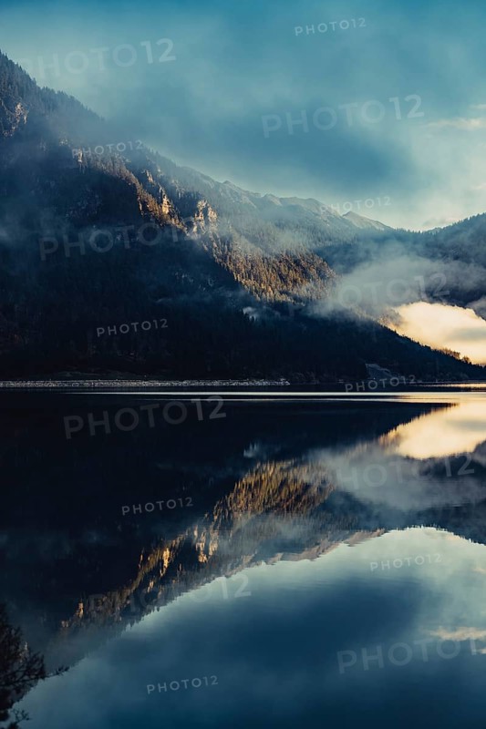 Sunrise with reflections in the Plansee in Tyrol in the Alps in Austria