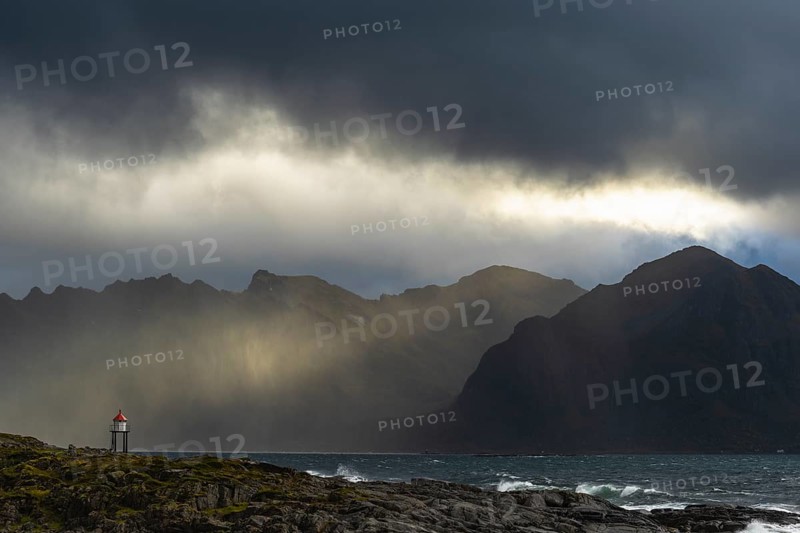 Sunbeams over coastal landscape and sea, Lofoten, Nordland, Norway, September 2020