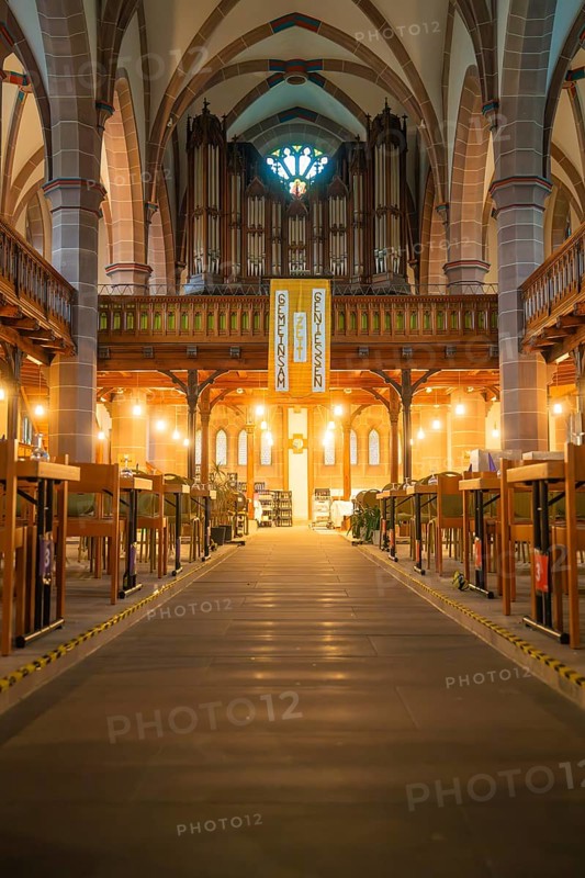 View into the nave of a church with organ and laid tables, Vesperkirche Calw, Black Forest, Germany