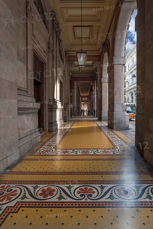 Arcaded walkway with mosaic floor from Palazzo della Borsa, built between 1907 and 1912, in Piazza de Ferrari, Genoa, Italy