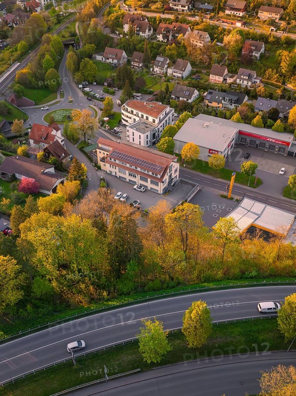 Aerial view of a residential area with streets and trees in autumnal colours at sunset, Nagold, district of Calw, Germany