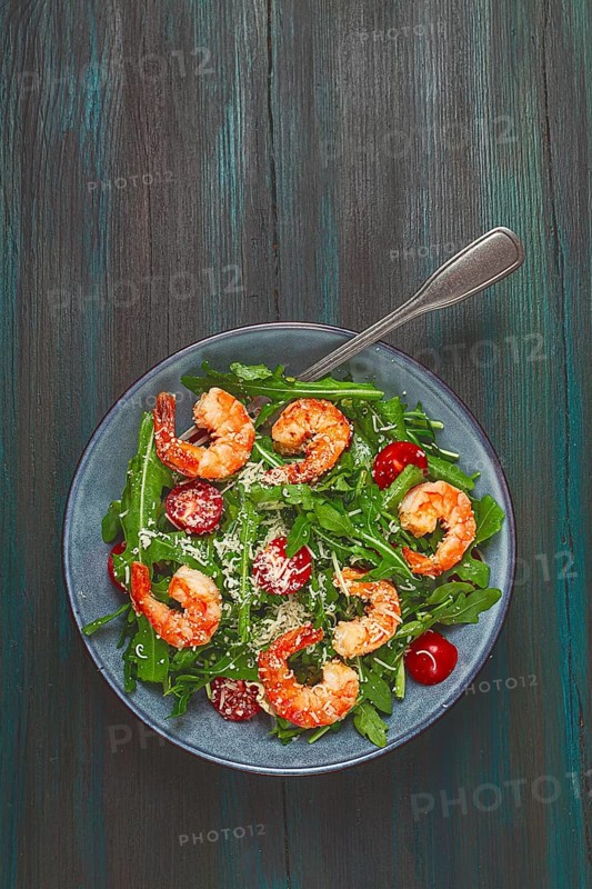 Shrimp salad with arugula and cherry tomatoes, with parmesan cheese, healthy food