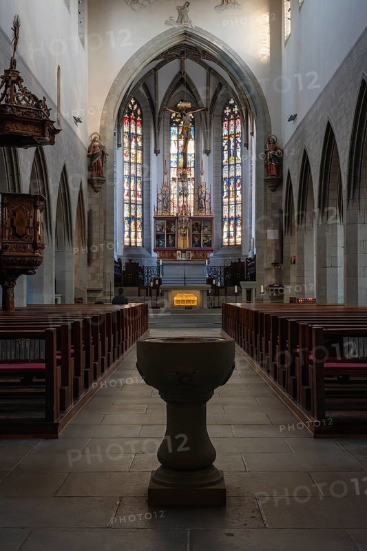 Interior view of the Radolfzell Cathedral of Our Lady with the baptismal font and the neo-Gothic high altar, district of Constance, Baden-Württemberg, Germany