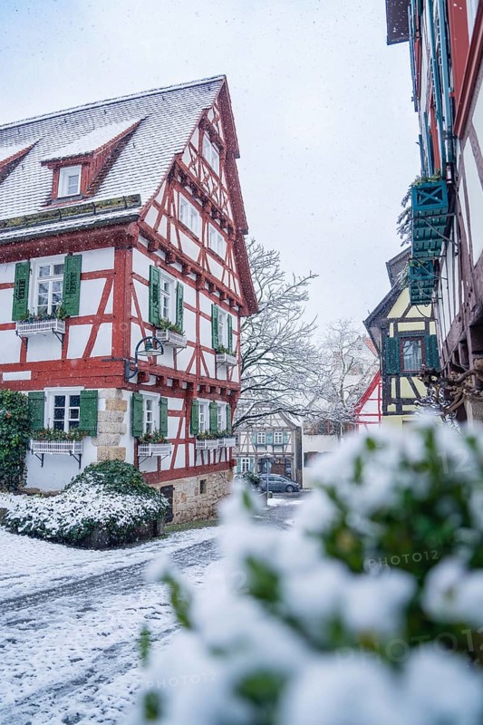 Snow-covered street with half-timbered houses in an idyllic winter landscape, Sindelfingen, Germany