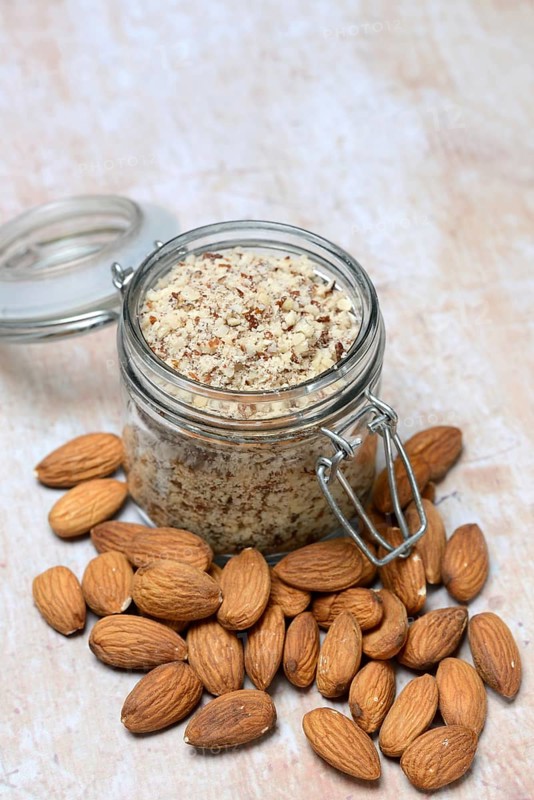 Almonds and ground almonds in glass, Prunus amygdalus