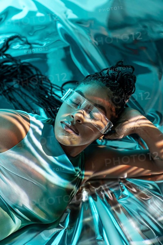 A futuristic African young woman in the metaverse, adorned with transparent glasses, lounges in a surreal digital environment. The scene captures a blend of virtual and reality