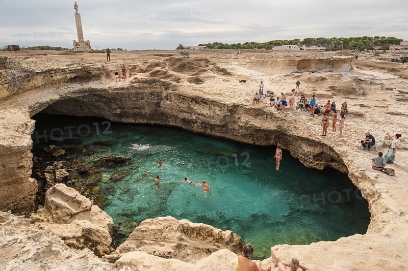 ROCA VECCHIA, ITALY - SEPTEMBER 28, 2018: Grotta Della Poesia is a very popular tourist attraction in region Plugia. People jump to the water from the rock