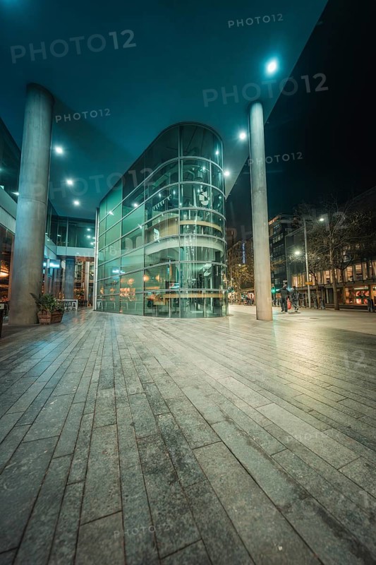 Architecturally modern building at night with bright lights and urban environment, New Year's Eve London, Great Britain
