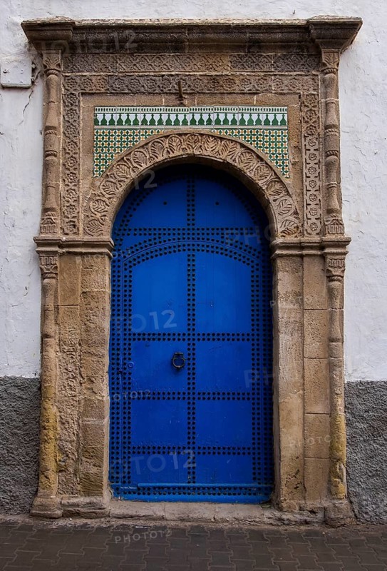 A blue door with ornate arch and decorative mosaic patterns in antique style, Essaouira, Morocco