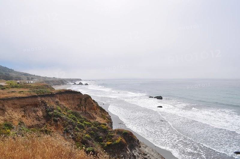 Rugged coastal landscape with cliffs and waves under cloudy sky, Humboldt Redwoods State Park, California, USA