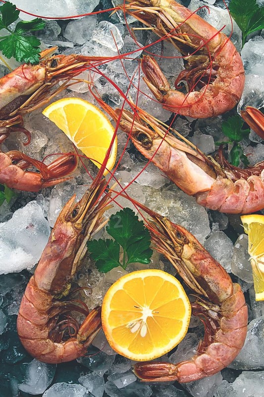Tiger prawns, boiled and frozen, on ice, top view, close-up, no people