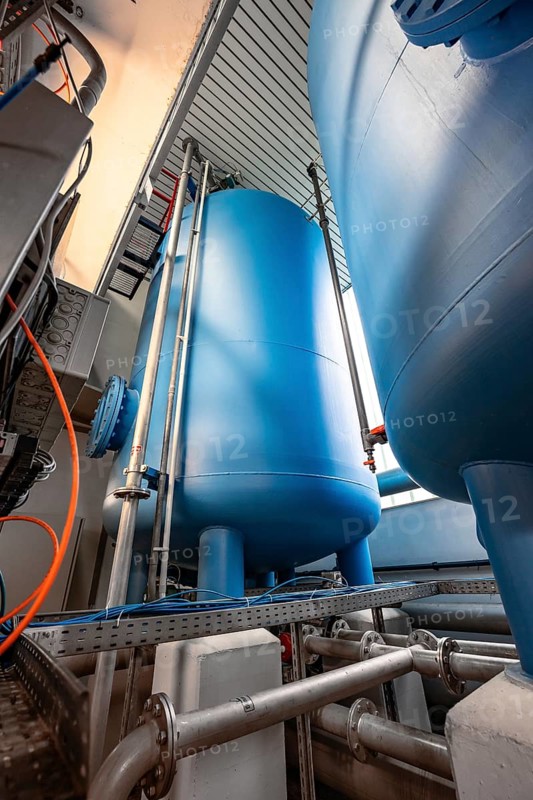 Large, blue tanks in a room full of technical equipment and pipes, ENCW Netze Calw waterworks, Calw, Black Forest, Germany