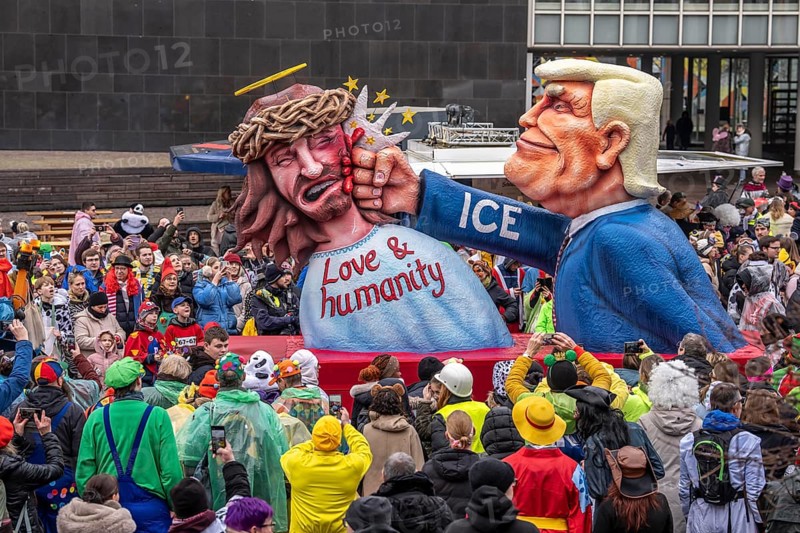 Rose Monday procession in Düsseldorf, theme car by wagon manufacturer Jacques Tilly, theme US President Donald Trump beats Jesus, ICE logo on his sleeve, against the domestic politics of the US government of North Rhine-Westphalia, Germany
