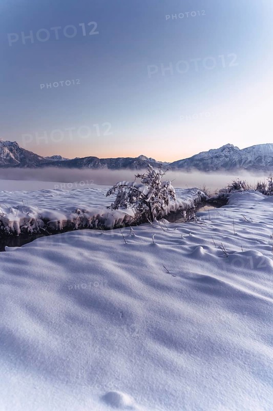 Shortly after sunset, twilight at Lake Hopfensee in the Allgäu in Bavaria in a winter landscape, Germany