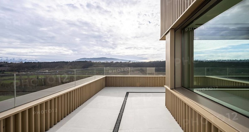 Contemporary open balcony showcasing panoramic natural vistas, modern architectural elements, and eco-friendly construction principles including energy-efficient designs