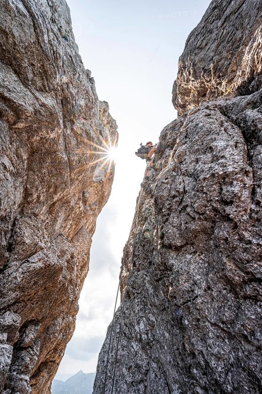 Climber on a climbing tour, abseiling, alpine climbing, crossing the Kampenwand, Sonnenstern, Chiemgau, Bavaria, Germany