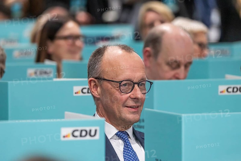 38th Federal Party Congress of the CDU of Germany in Stuttgart. Federal Chancellor Friedrich Merz has left the stage and podium and is sitting in the ranks of delegates from the state association of North Rhine-Westphalia during the election. Privacy when voting by secret ballot. Stuttgart, Baden-Württemberg, Germany