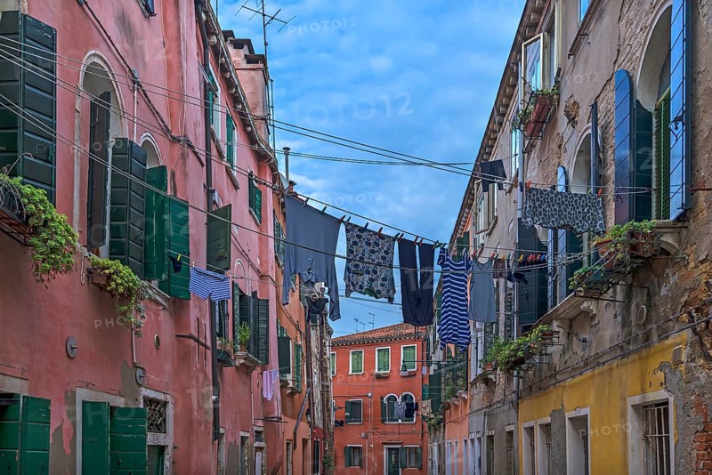 Colourful laundry stretched on linen between houses, Castello district, Venice, Veneto, Italy