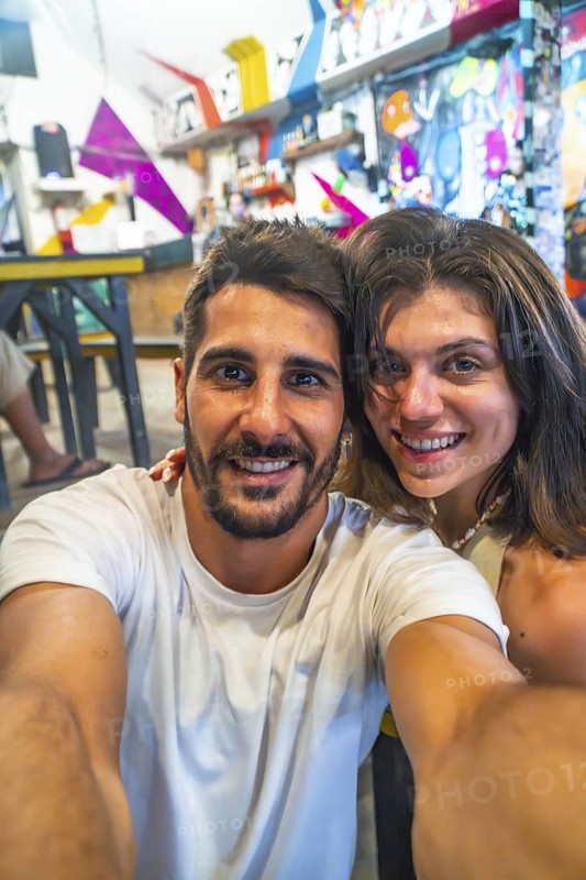 Tourists taking a selfie in a restaurant in siargao island, philippines, enjoying their holidays