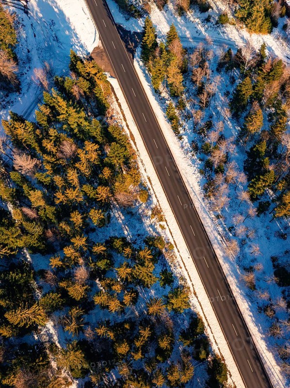 Bird's eye view of a snow-covered road in a straight line, Seewald, Black Forest, Germany