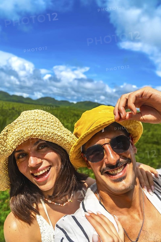 Tourists couple smiling and enjoying summer holidays in a coconut plantation on siargao island, philippines