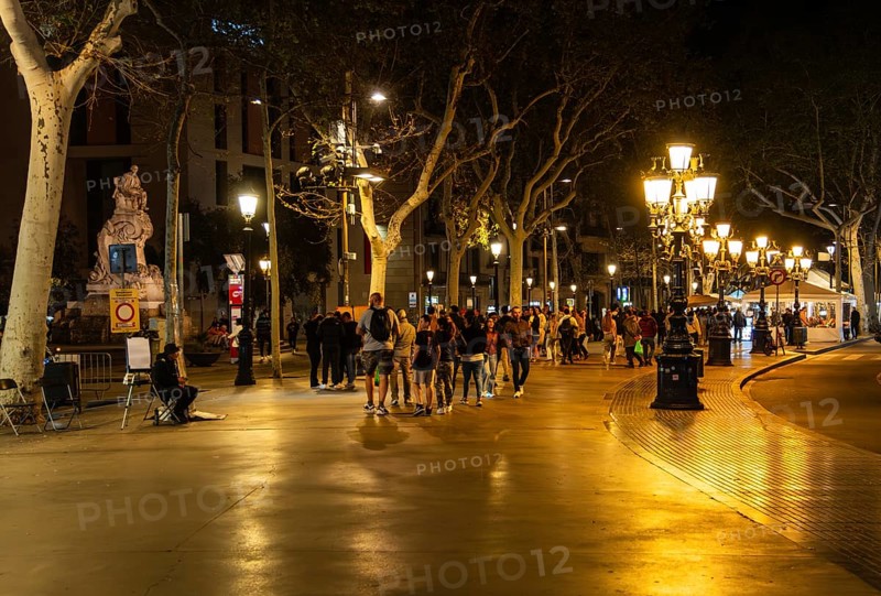 Night shot of catering and tourists on the Ramblas in Barcelona, Spain
