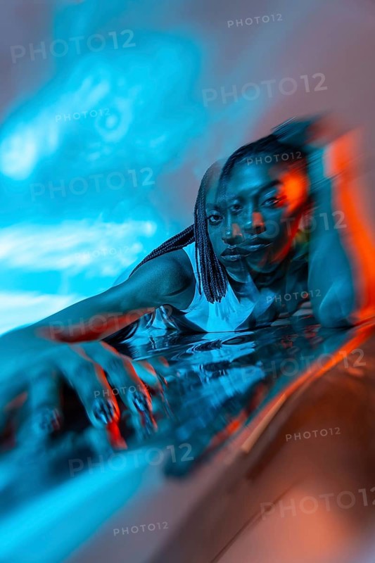 A futuristic image of a young African woman immersed in a vibrant metaverse environment, featuring dynamic lighting and a digital ambiance that evokes innovation and technology