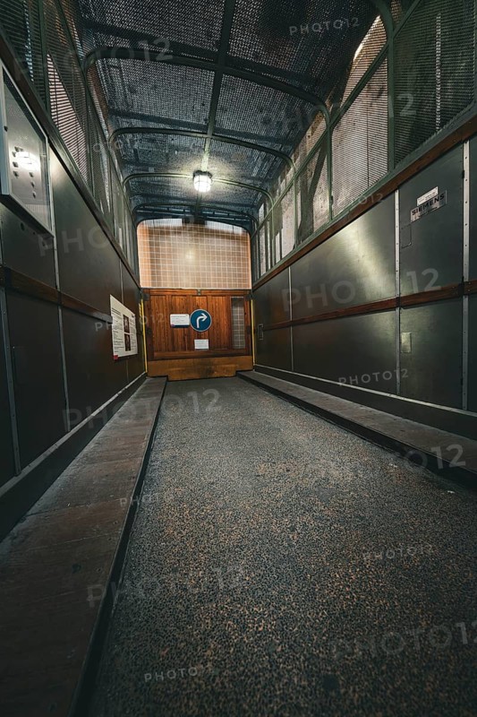 Industrial metal lift with illuminated interior, old Elbe tunnel, Hamburg, Germany