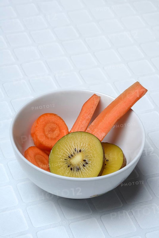 Sliced carrot and kiwi slices in peel, kiwi fruit and carrot