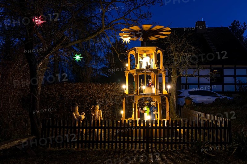 Christmas pyramid with wooden figures in the village of Unkersdorf in the evening, Dresden, Saxony, Germany