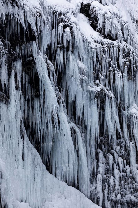 Icicles on the rock face at Skogafoss waterfall, Sudurland, Iceland