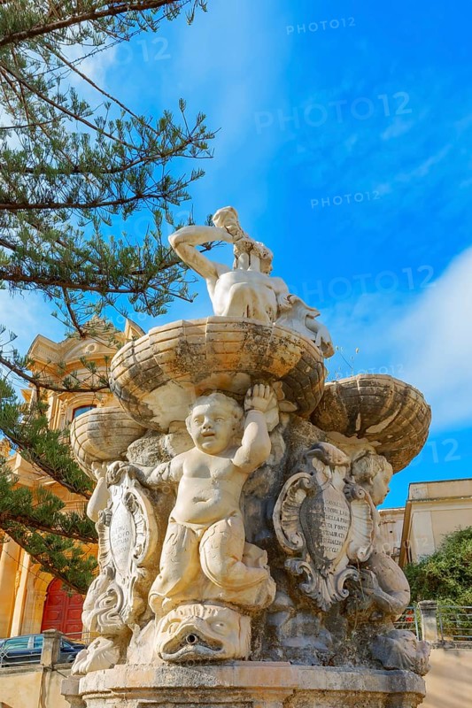 View of Hercules fountain and San Domenico church in the background, Noto Valley, Sicily, Italy