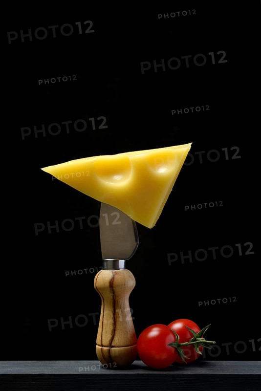 A piece of Swiss Emmental cheese on a cheese knife
