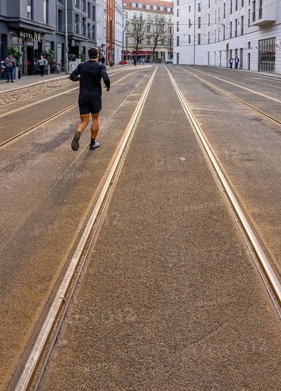 Public transport strike, lonely jogger on Große Präsidenternstraße where the tram terminal is actually located, Berlin, Germany