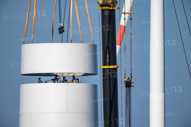 Construction site of the new Bedburg 3 wind farm, on recultivated open-cast mining site, 9 wind power plants with an output of 60 megawatts are being built, installation of the wind turbine tower operated by RWE and the city of Bedburg, North Rhine-Westphalia, Germany