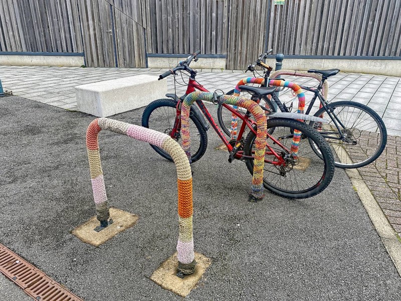 Bikes in an urban area chained to a colorful bicycle rack, Oban, Scotland, Great Britain