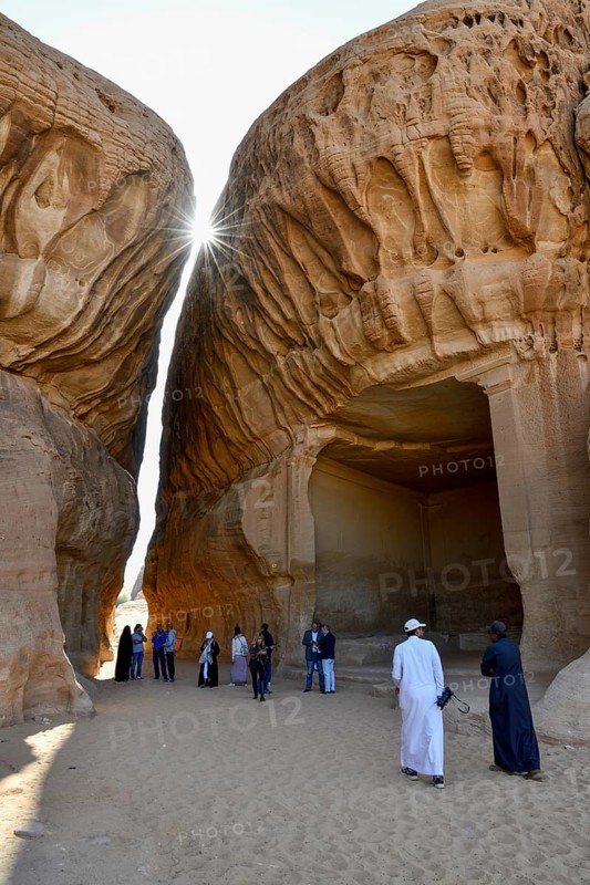 Tourists in front of the divan, Nabataean cult site carved into the rock at Jabal Ithlib, Hegra or Mada'in Salih, AlUla region, Medina province, Saudi Arabia, Arabian Peninsula