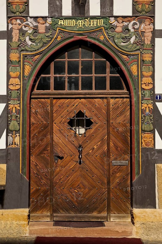 Historic wooden door with carvings on the half-timbered house Lange Bank from 1889 in the Old Town, UNESCO World Heritage Site, Goslar, Lower Saxony, Germany