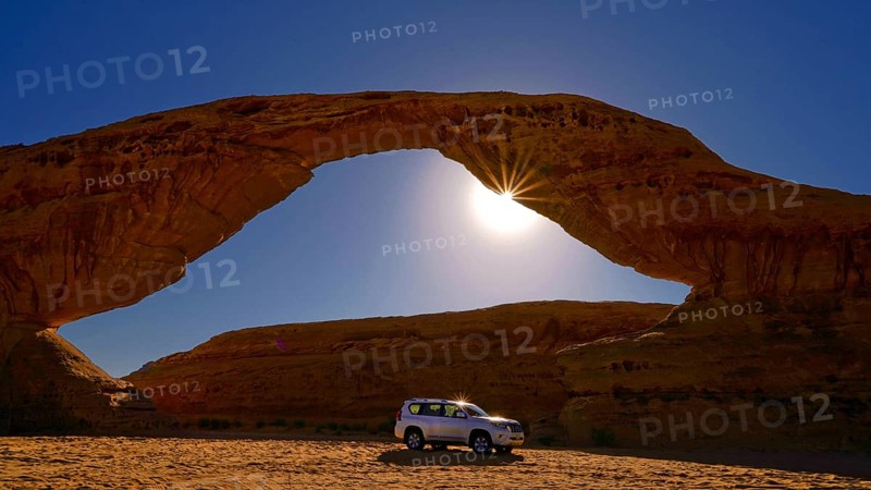 Middle East, Saudi Arabia, Nabataeergran in Al Ula, jeep in front of Rainbow Arch, Al Ula