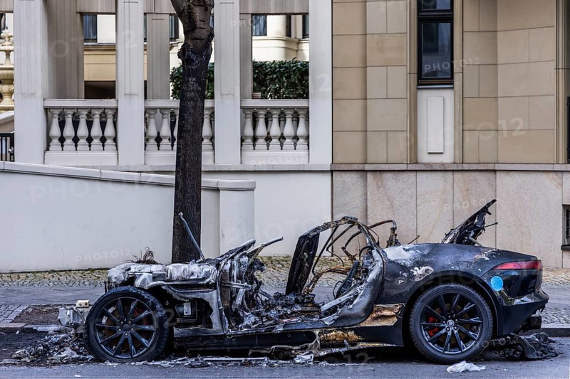 Burnt out Jaguar car on the side of the road, Mitte, Berlin, Germany