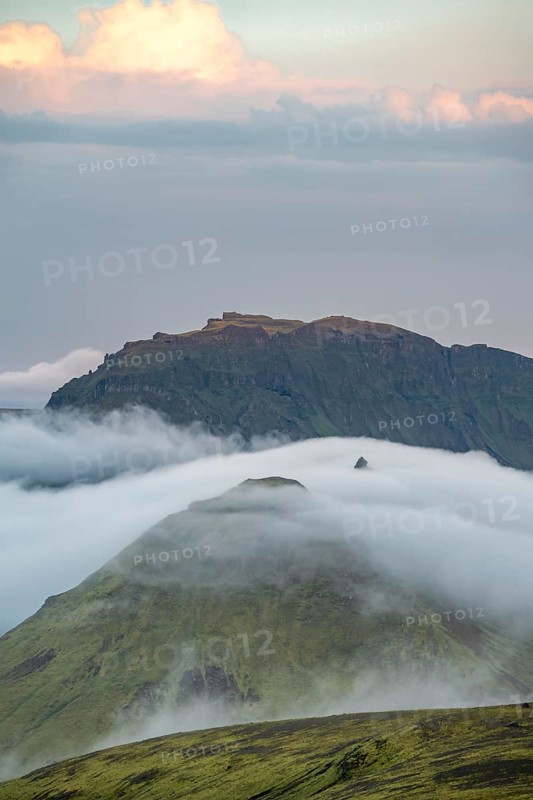 Fog between mountains, moss-covered volcanic mountain landscape, at sunset, Pakgil, Iceland