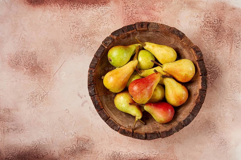 Pears, Duchess variety, small pears, early harvest, in a wooden plate, top view, no people
