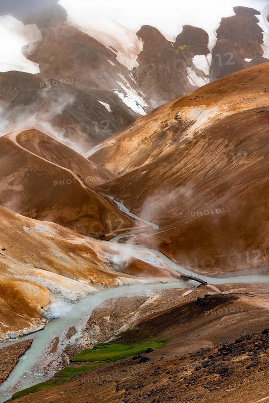 Bridge and steaming streams between colourful rhyolite mountains in the Hveradalir geothermal area, Kerlingarfjöll, Icelandic Highlands, Iceland