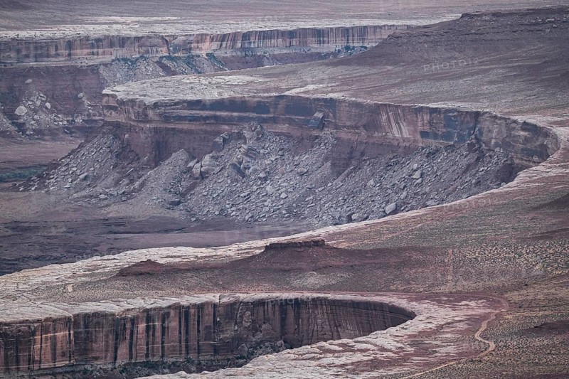 This breathtaking view of Canyonlands National Park showcases its rugged terrain and eroded rock formations, offering a glimpse into the park's geological history and natural beauty