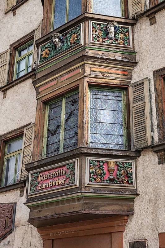 Detailed view of the former Gasthaus zum goldenen Becher in the historic old town of Rottweil, which was already mentioned as an inn in 1713. The wooden bay window was artfully decorated by the well-known German sculptor and mask carver German Burry, Rottweil district, Baden-Württemberg, Germany