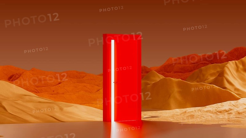A bright, red door rests in the middle of a surreal desert landscape. A light glows from the door, reflected in a shallow body of water