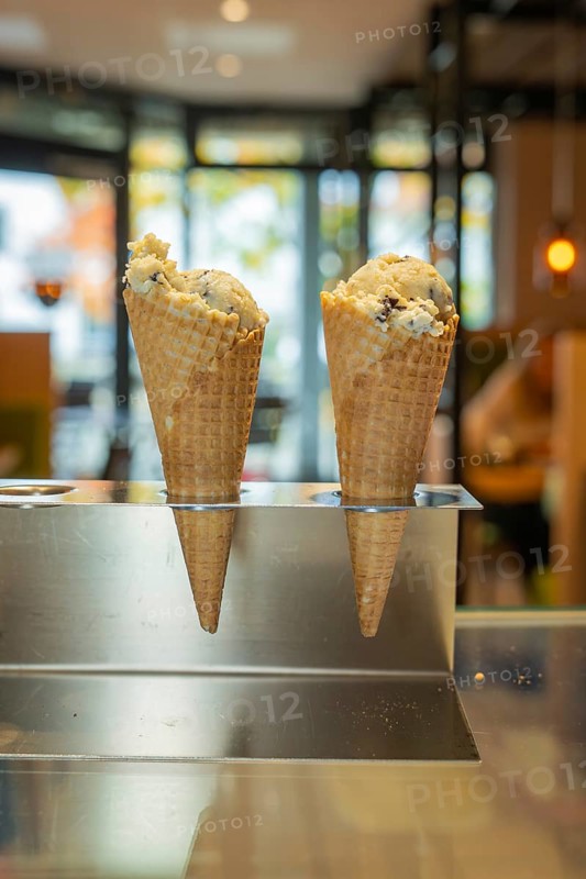 Two waffle croissants with ice cream in a warm, cosy café with large glass windows in the background, autumn creations at Cafe Kuh, Deckenpfronn, Germany
