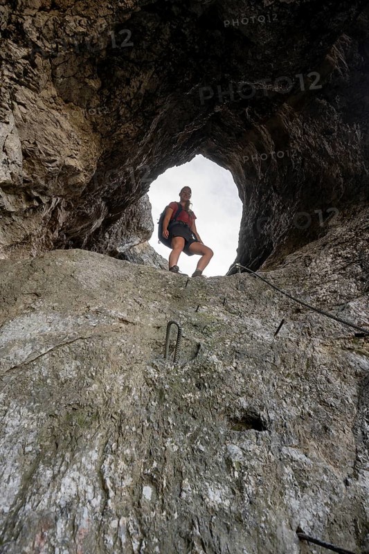 Hiker climbing through the Schindertor, Schinder, Tegernsee mountains in the Mangfall mountains, Germany