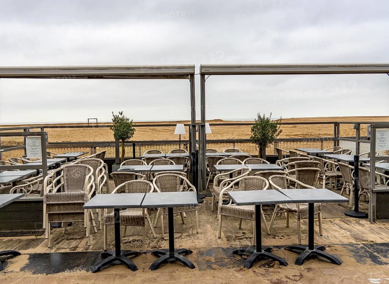 Winter break, closed terraces of catering establishments on Zeedijk-Knokke, beach promenade in Knokke-Heist, on the North Sea beach, dreary winter day, mostly apartment buildings with rental or condominiums, high-rise buildings on the street, Belgium