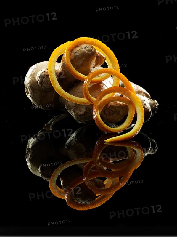 Orange peel, ginger tuber, fruit and vegetable decoration on black background, studio shot